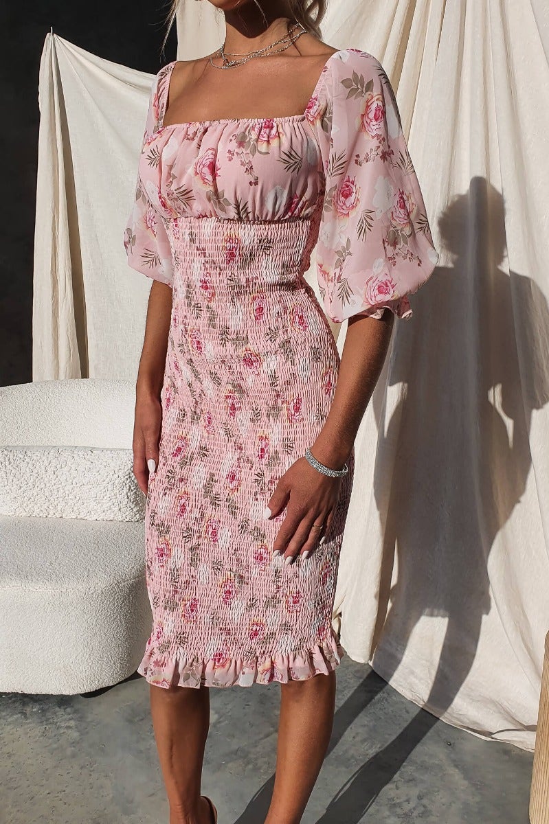 Arabella Midi Dress in floral pink fabric with elastic sleeves and fitted bodice, perfect for summer events.