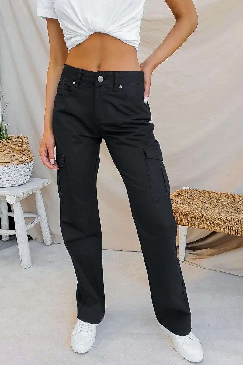 Bowie Cargo Pants in black, featuring wide legs and multiple pockets, styled with a cropped top and sneakers.
