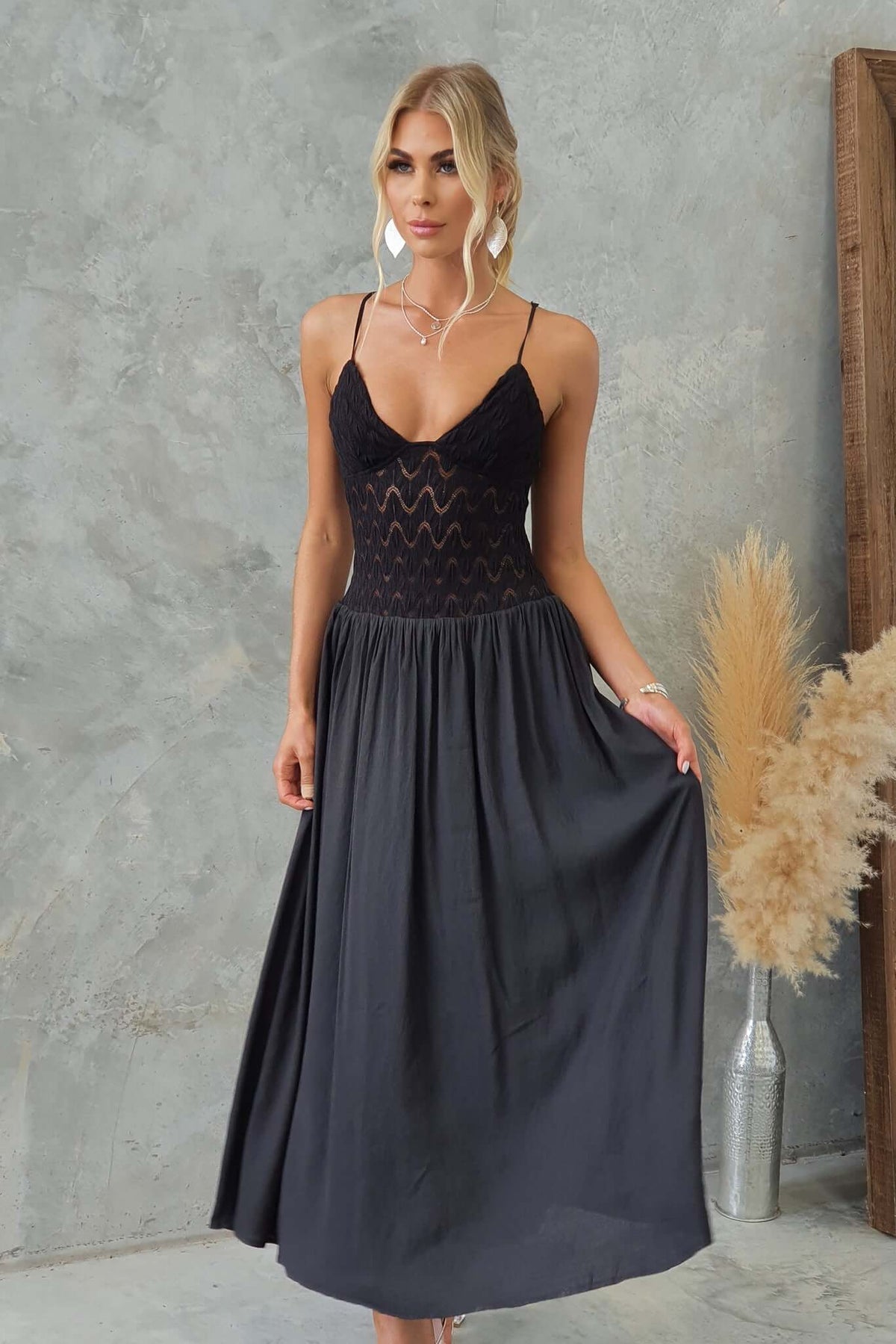 Black Thaisa maxi dress with adjustable straps and lace bodice, featuring a flowing skirt and lined design.