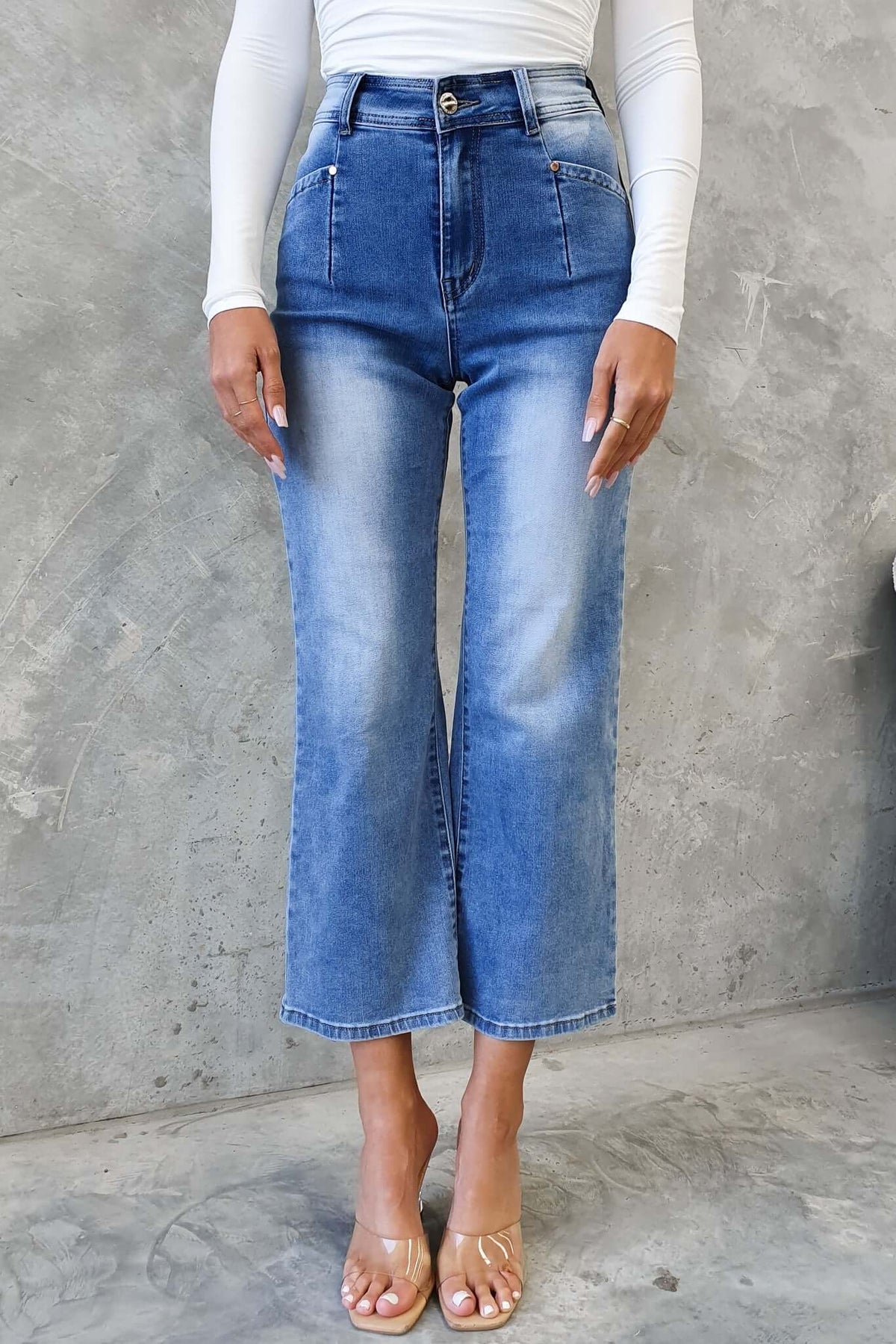 Model wearing Blanca Jeans, mid-high waist denim with wide legs, front and back pockets, showcasing a stylish fit.