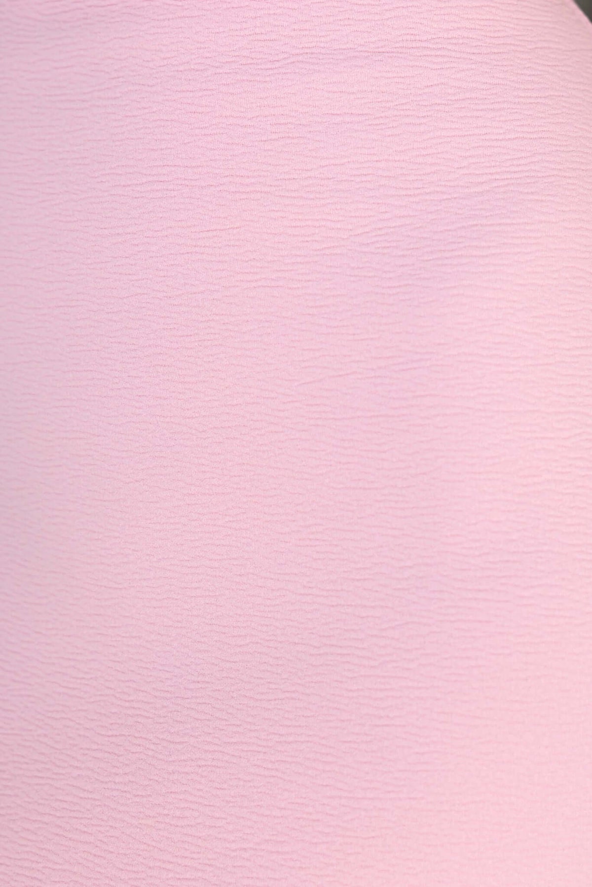 Textured pink fabric showcasing the material of the Qonway Maxi Dress with a soft, stretch finish.