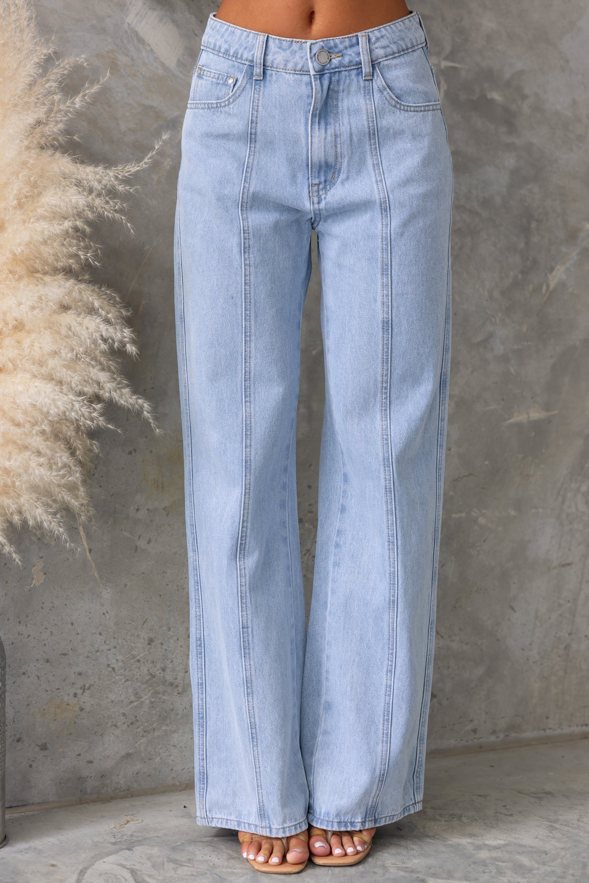 Light blue mid-high waist Billie jeans featuring wide legs and front and back pockets.