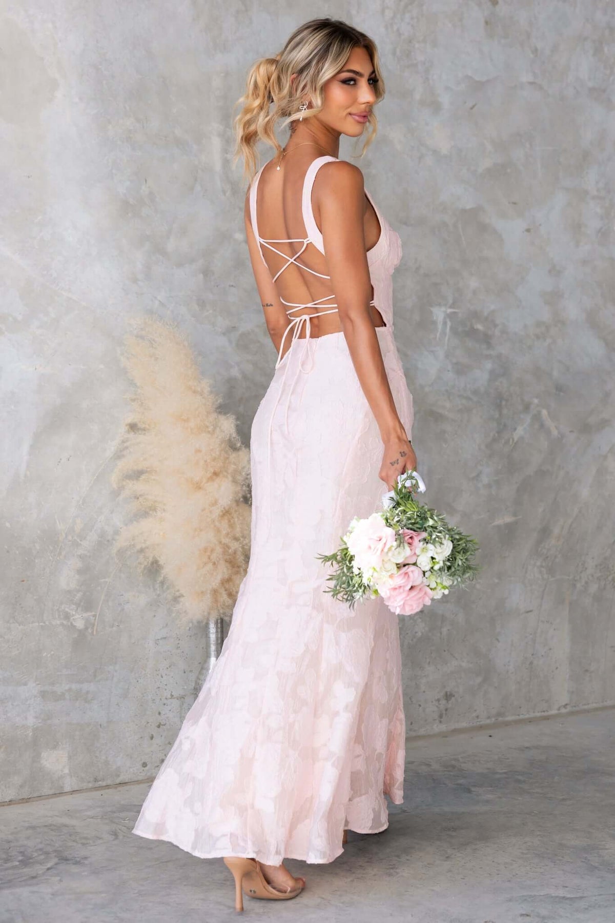 Remma Maxi Dress in light pink, showcasing lace-up back and slight fishtail hem, perfect for bridal occasions.