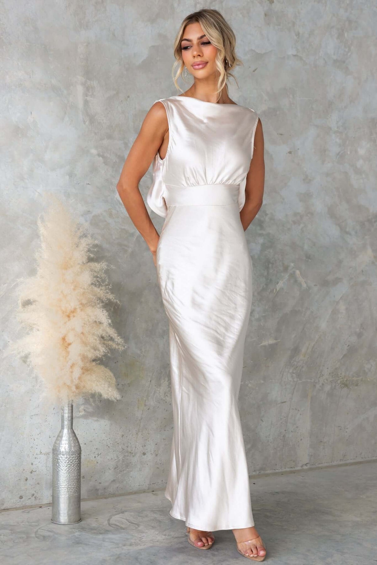 Silvia Maxi Dress in satin with boat neckline, draping back, and stylish tie, perfect for elegant occasions.