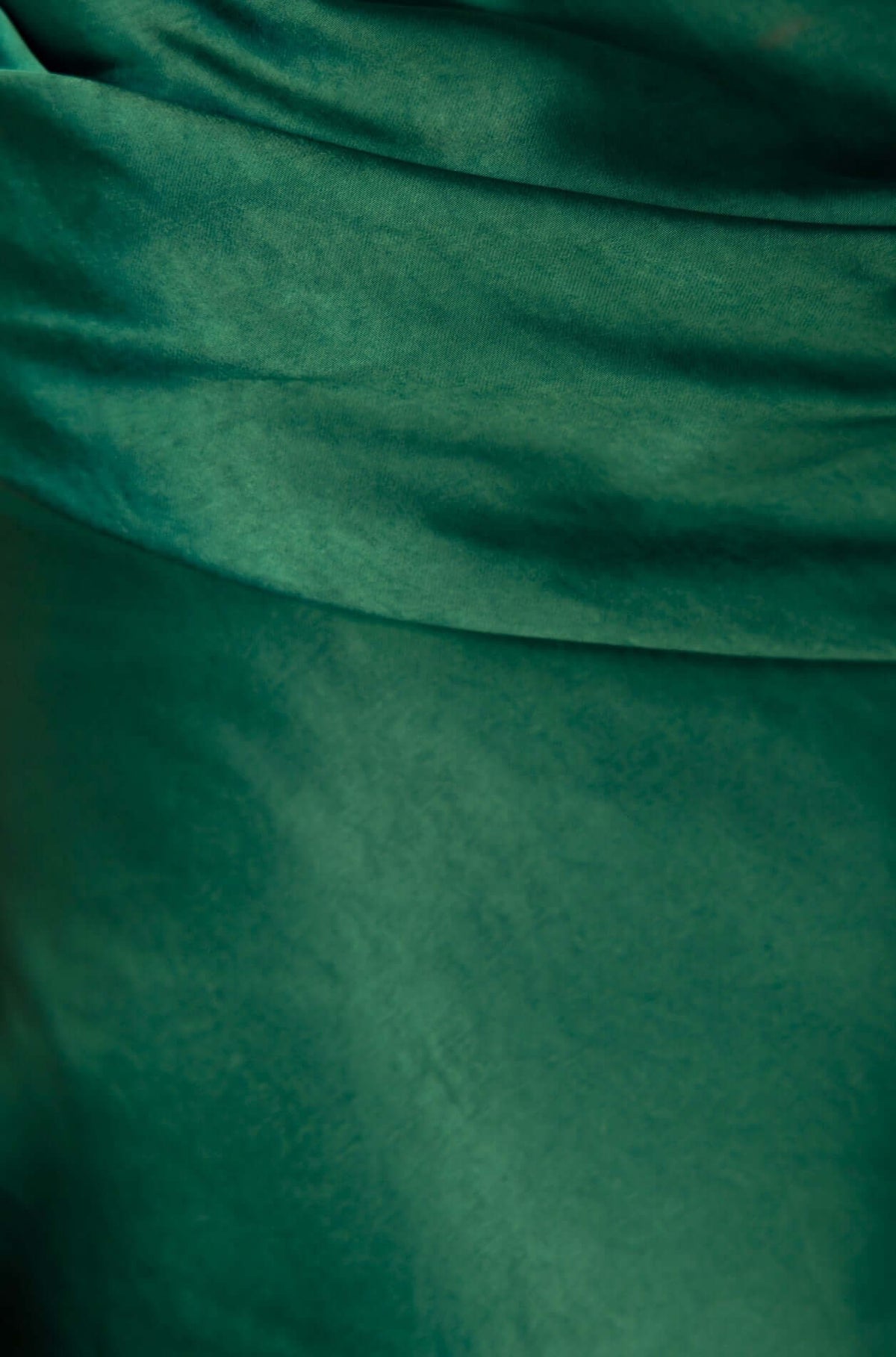 Close-up of lush green satin fabric with gathered details, perfect for a stylish Brighton Midi Dress.
