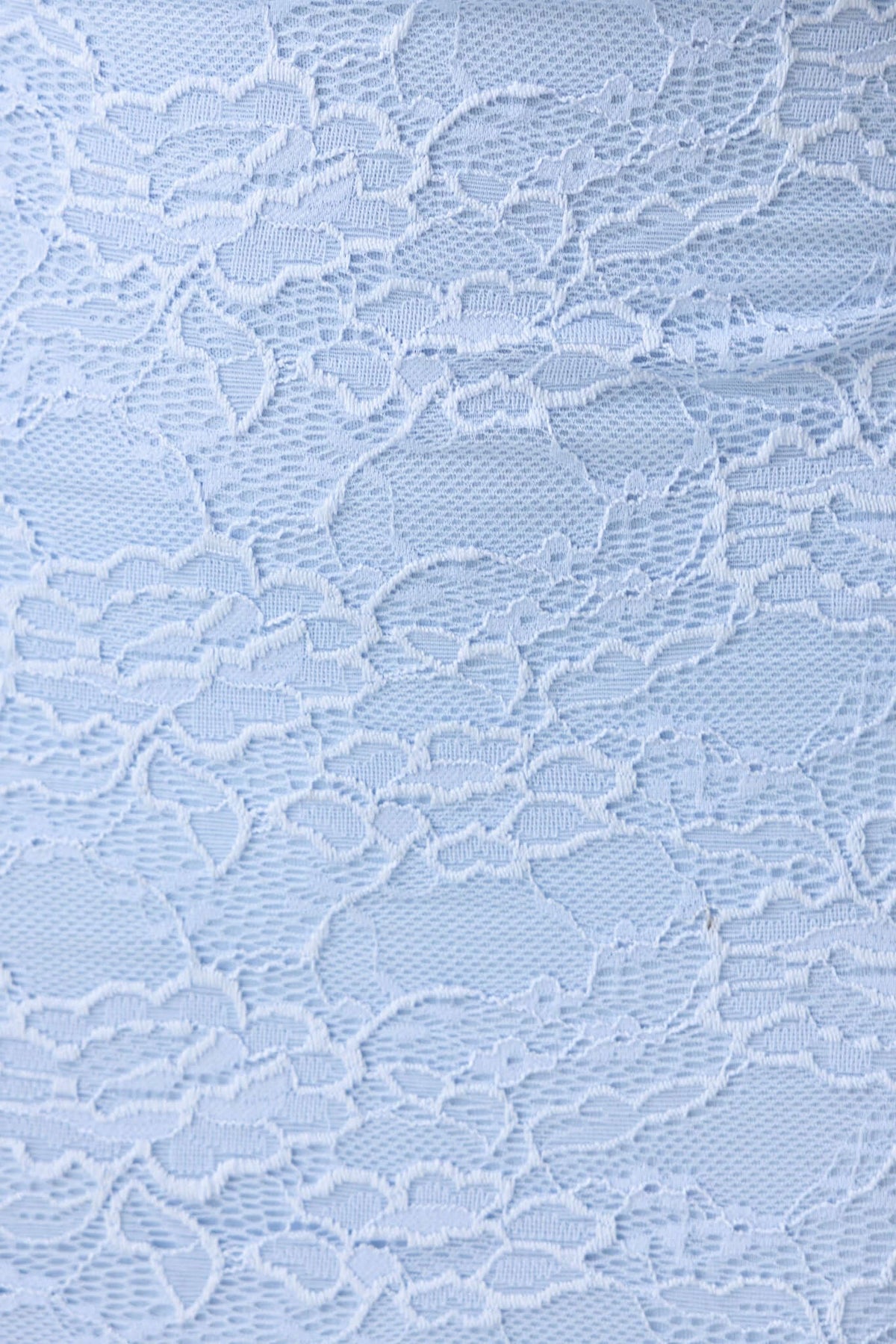 Close-up of light blue lace fabric with floral pattern, perfect for elegant designs like the Meriden Maxi Dress.