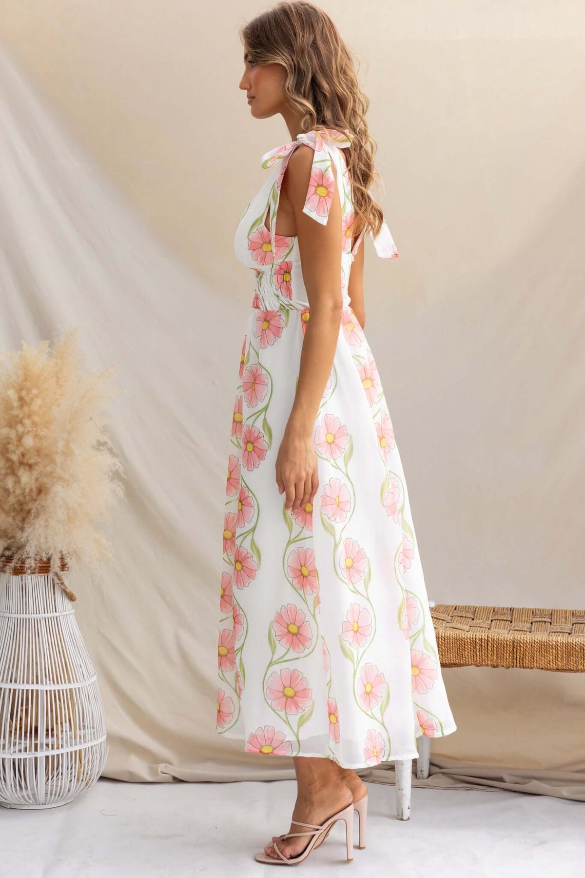 Torrance Maxi Dress featuring adjustable tie straps and floral patterns, perfect for warm weather occasions.