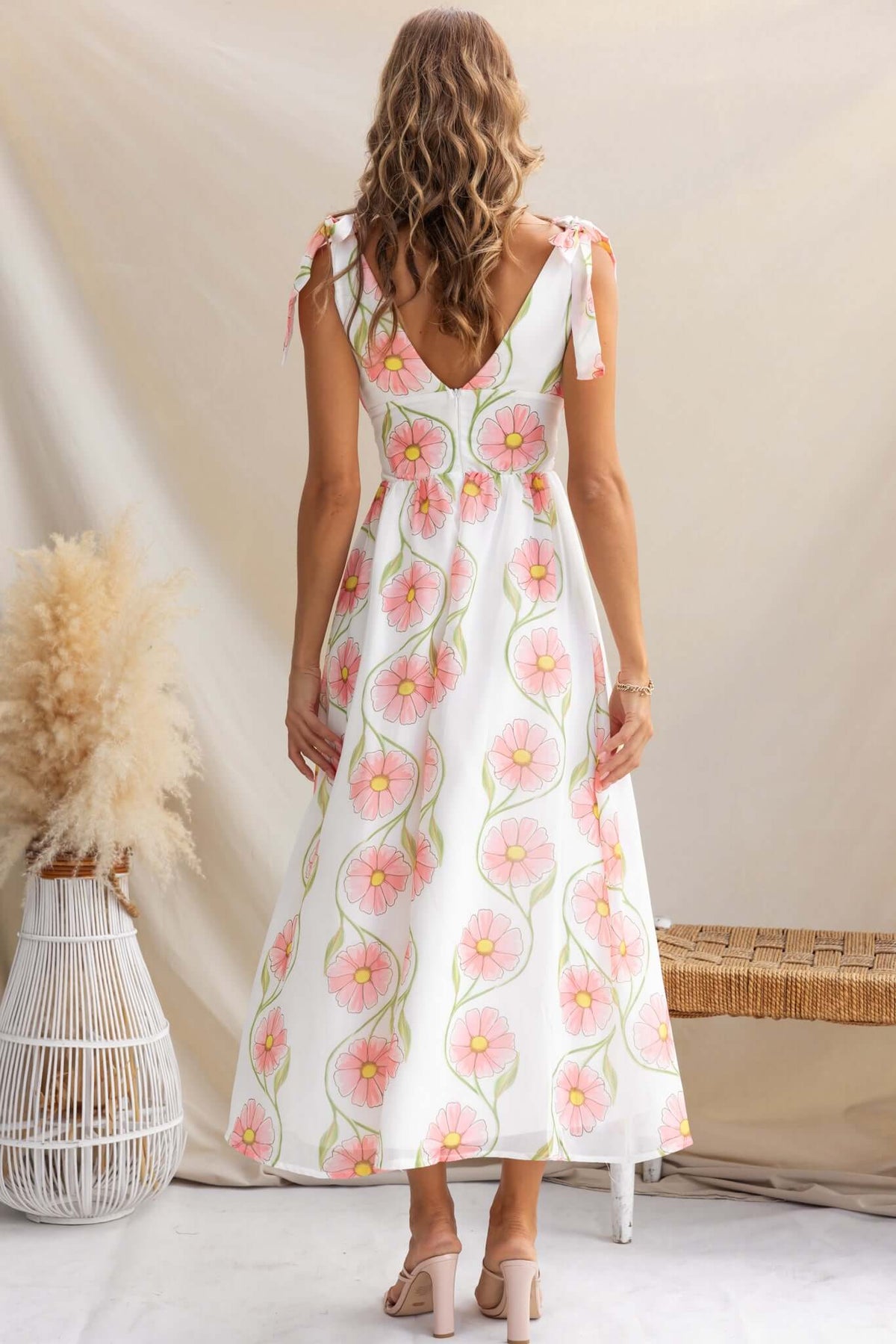 Back view of Torrance Maxi Dress featuring adjustable tie straps and floral pattern.