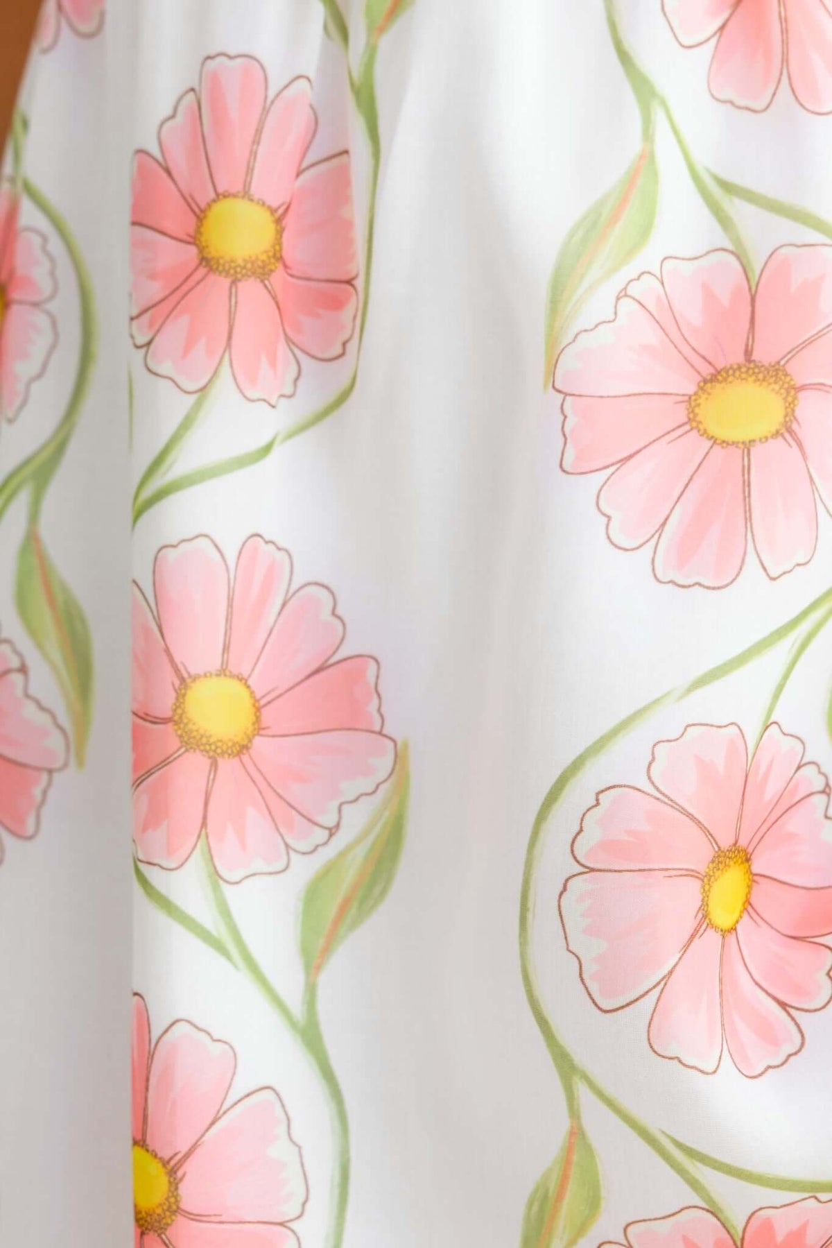 Detail of Torrance Maxi Dress featuring pink floral print on a white background, showcasing elegant design and feminine style.