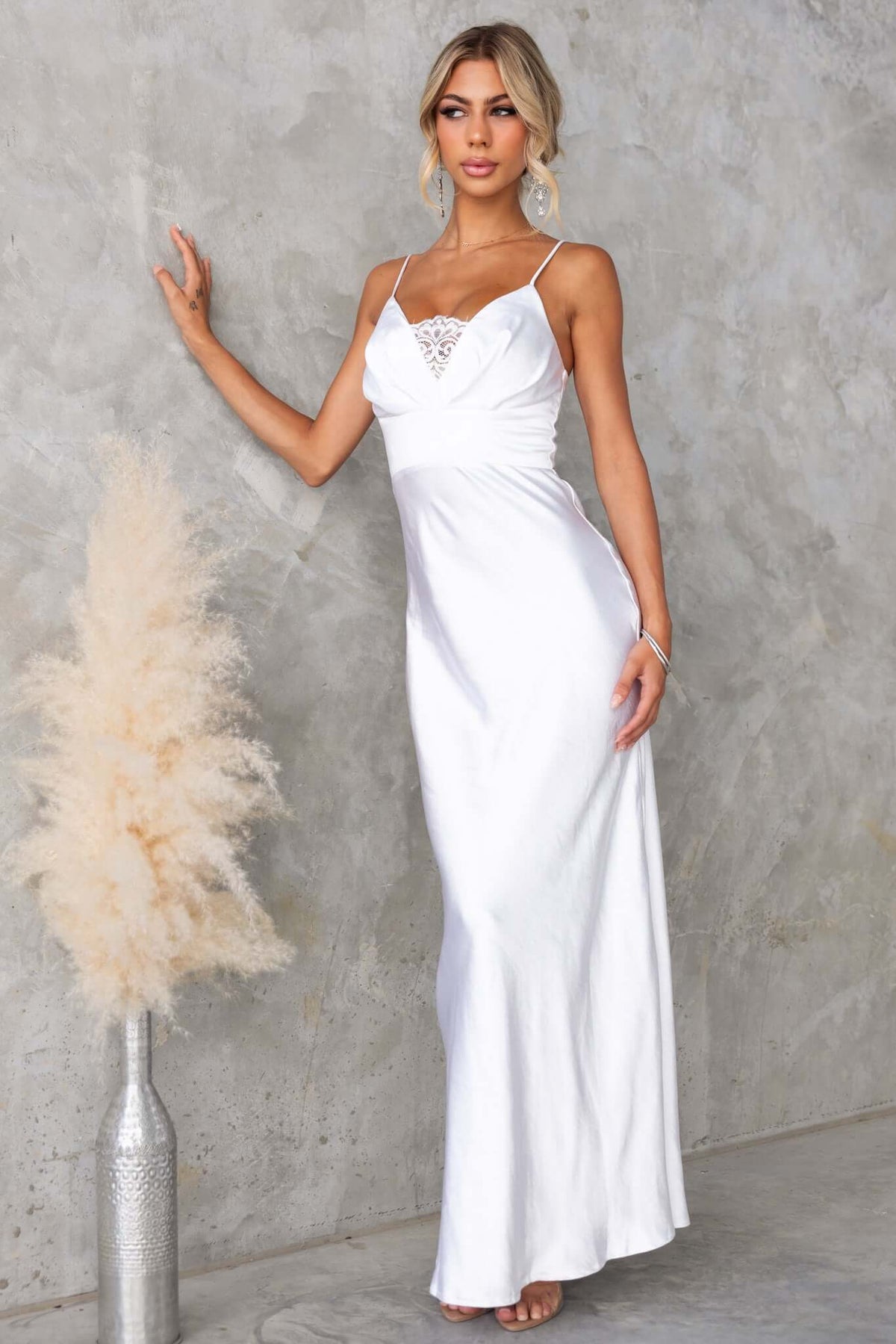 Elegant Maricia Maxi Dress in white with adjustable straps and lace panel detail, perfect for special occasions.