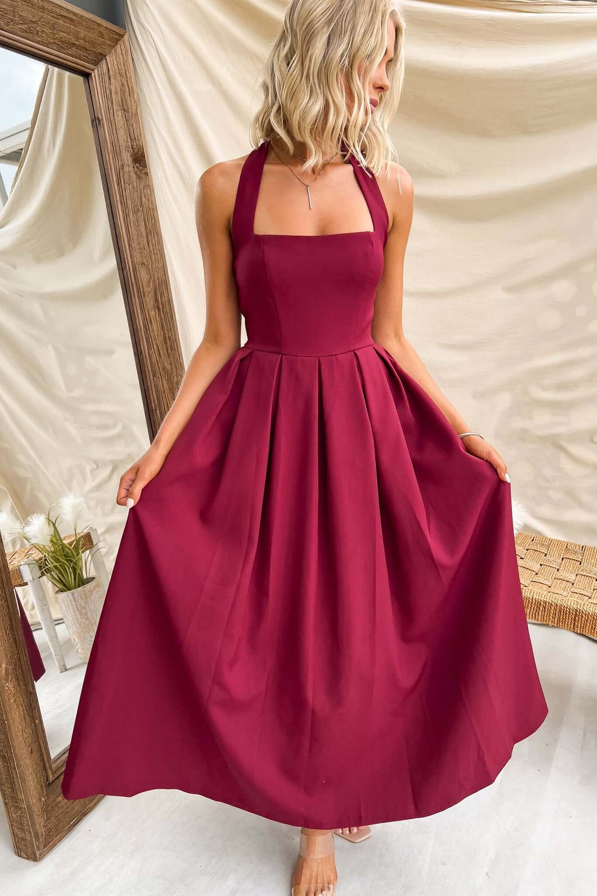 Jhene Maxi Dress in burgundy, featuring a square neckline and halter straps, styled with a flowing skirt.