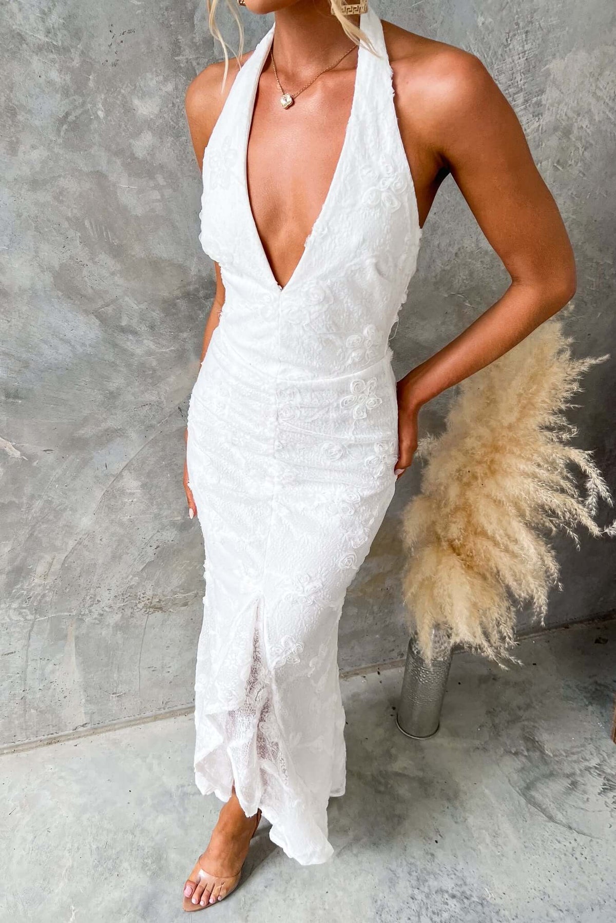 Metrick Maxi Dress by Amaroso Bridal, featuring a halter V-neckline, textured fabric, and a fishtail hem.