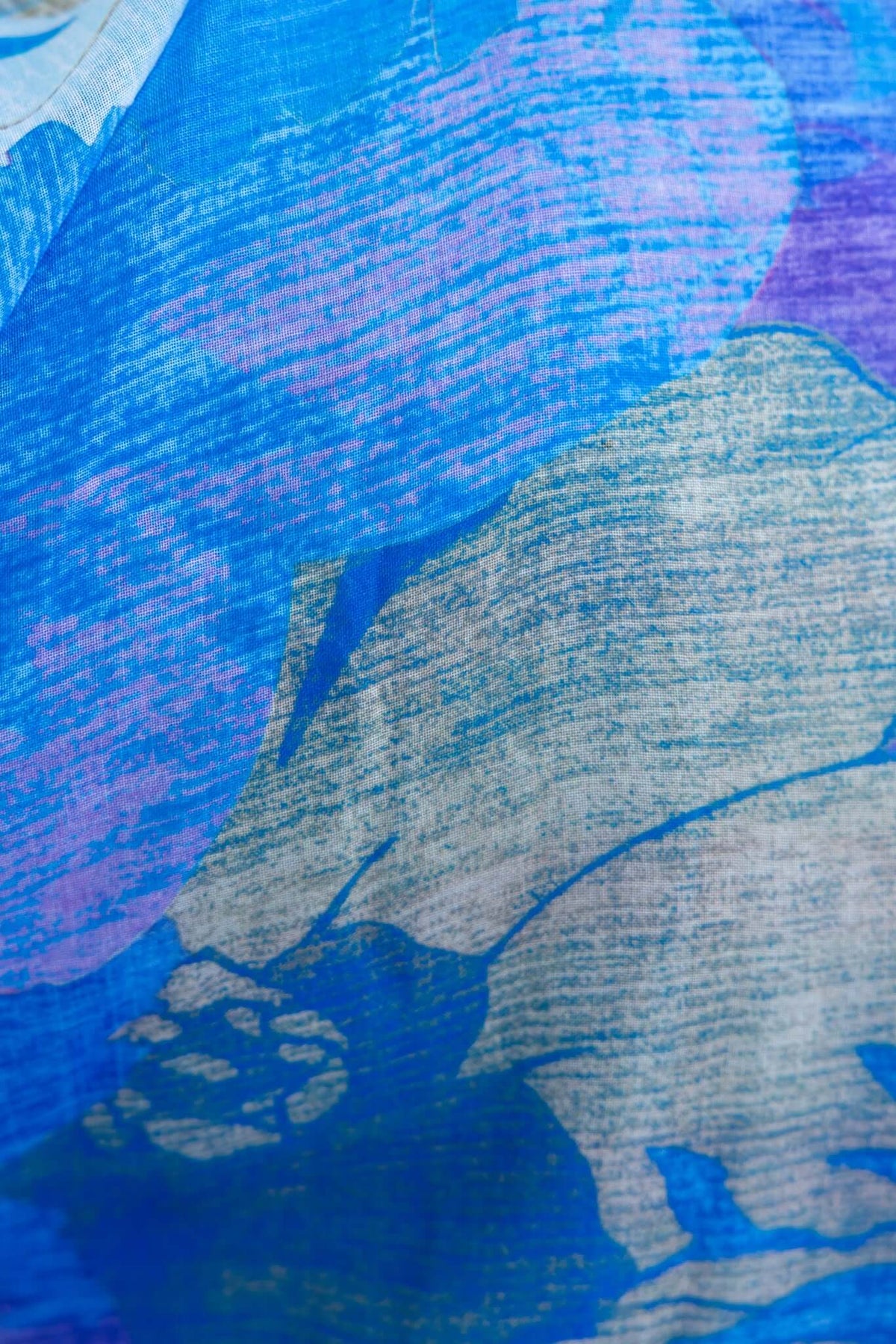Close-up of vibrant blue and purple textile pattern on a Burkes Midi Dress.