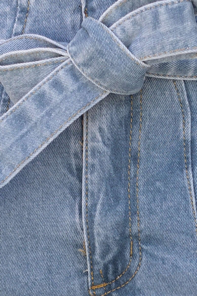 Close-up of New Hope Paper Bag Jeans showcasing the removable fabric tie belt and denim texture.