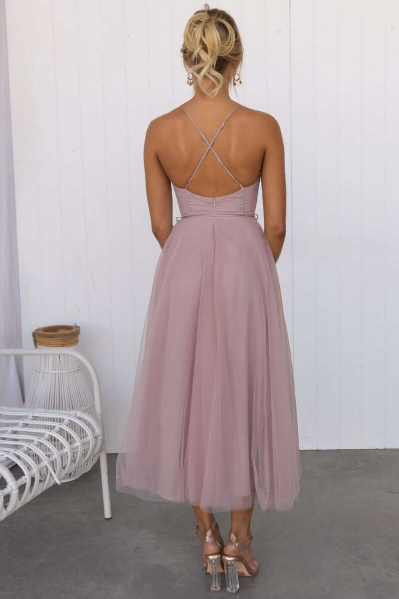 Back view of the Florence Midi Dress featuring adjustable cross-over straps and a flowy tulle skirt in soft mauve.