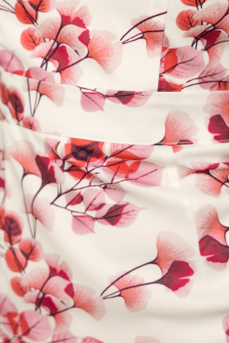 Close-up of floral print fabric on the Flourish Midi Dress featuring pink and red blooms.