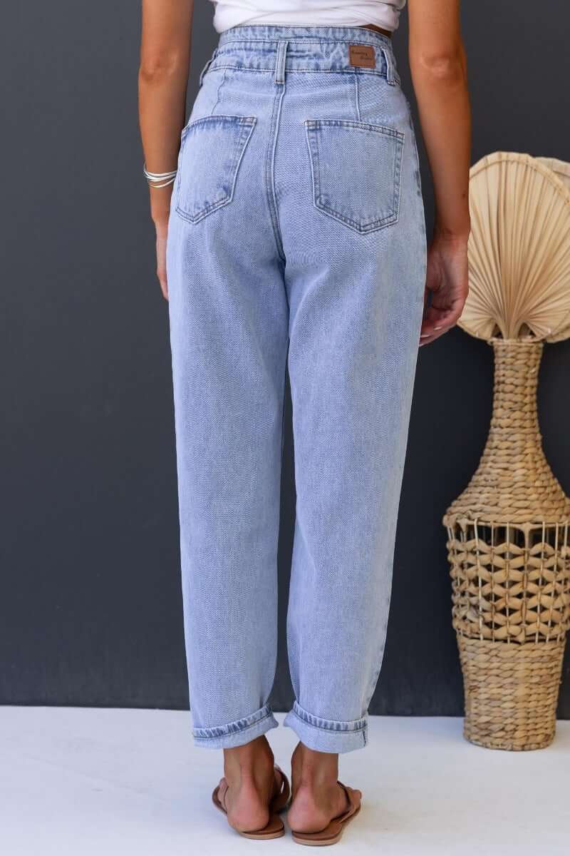 Back view of Shaylan Mom Jeans featuring mid-high waist, wide legs, and pockets, styled casually with sandals.