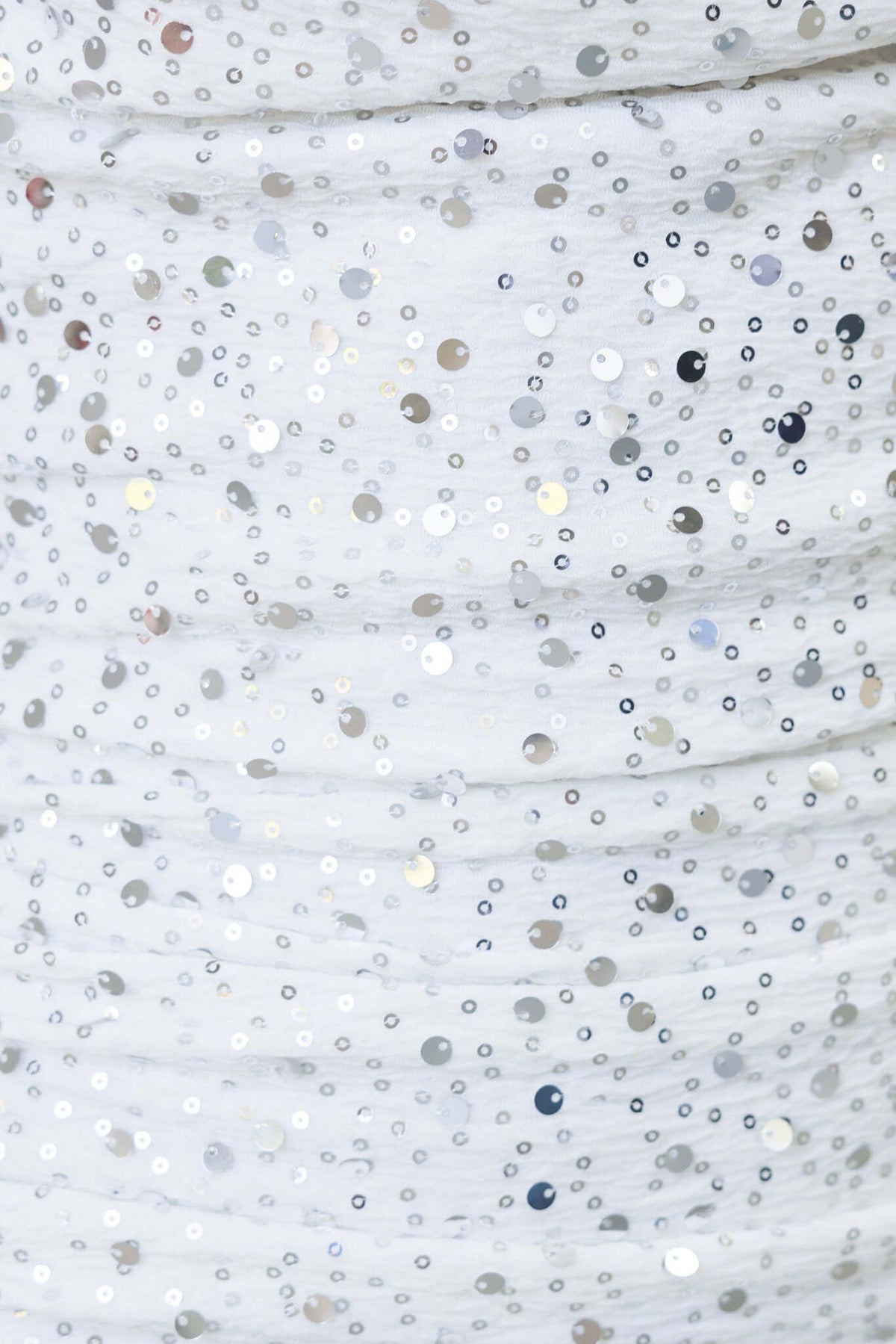 Close-up of sequins on indigo maxi dress, showcasing delicate fabric with shimmering embellishments.