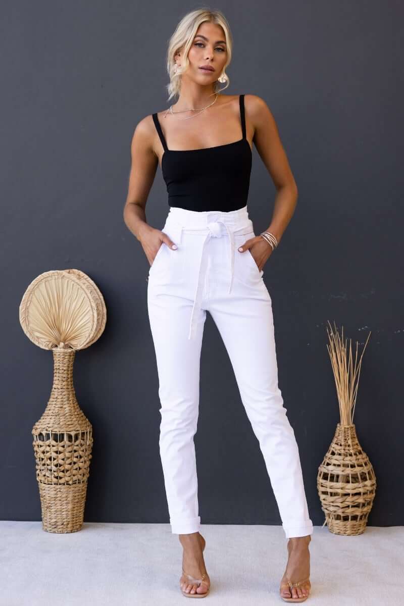Model wearing New Hope Paper Bag Jeans with a removable belt, featuring high waist and pockets, styled with a black top.