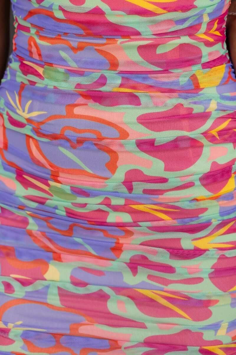 Multi-colour abstract print dress with ruching and adjustable tie halter neckline, perfect for summer styles.