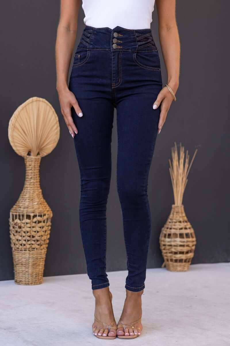Dark navy Quiver Jeans featuring mid-high waist, pockets, lattice detail at hips, and a stretchy fit.