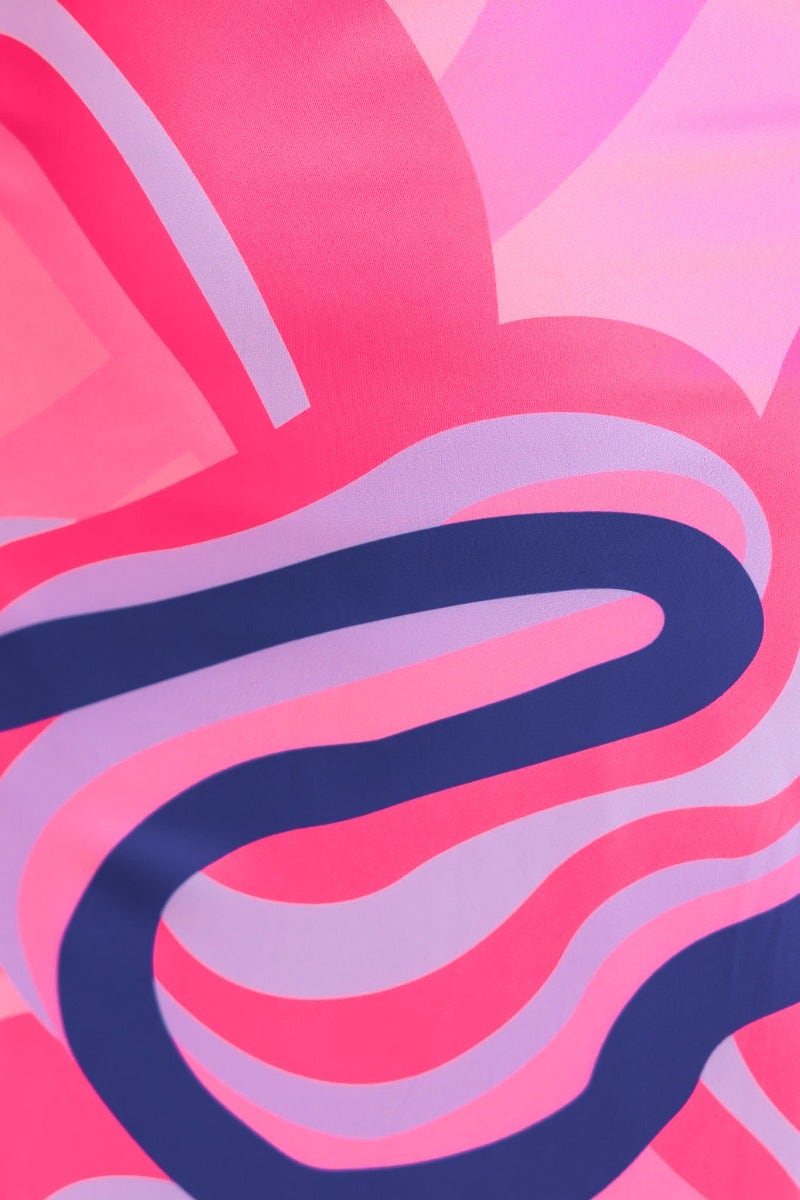 Colorful abstract design in shades of pink and purple on satin fabric, showcasing vibrant patterns for stylish fashion.