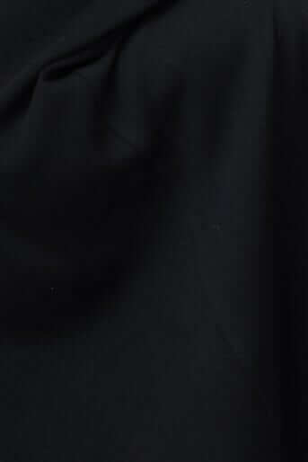 Close-up of ribbed black fabric showcasing Odeya top's texture and stretch.