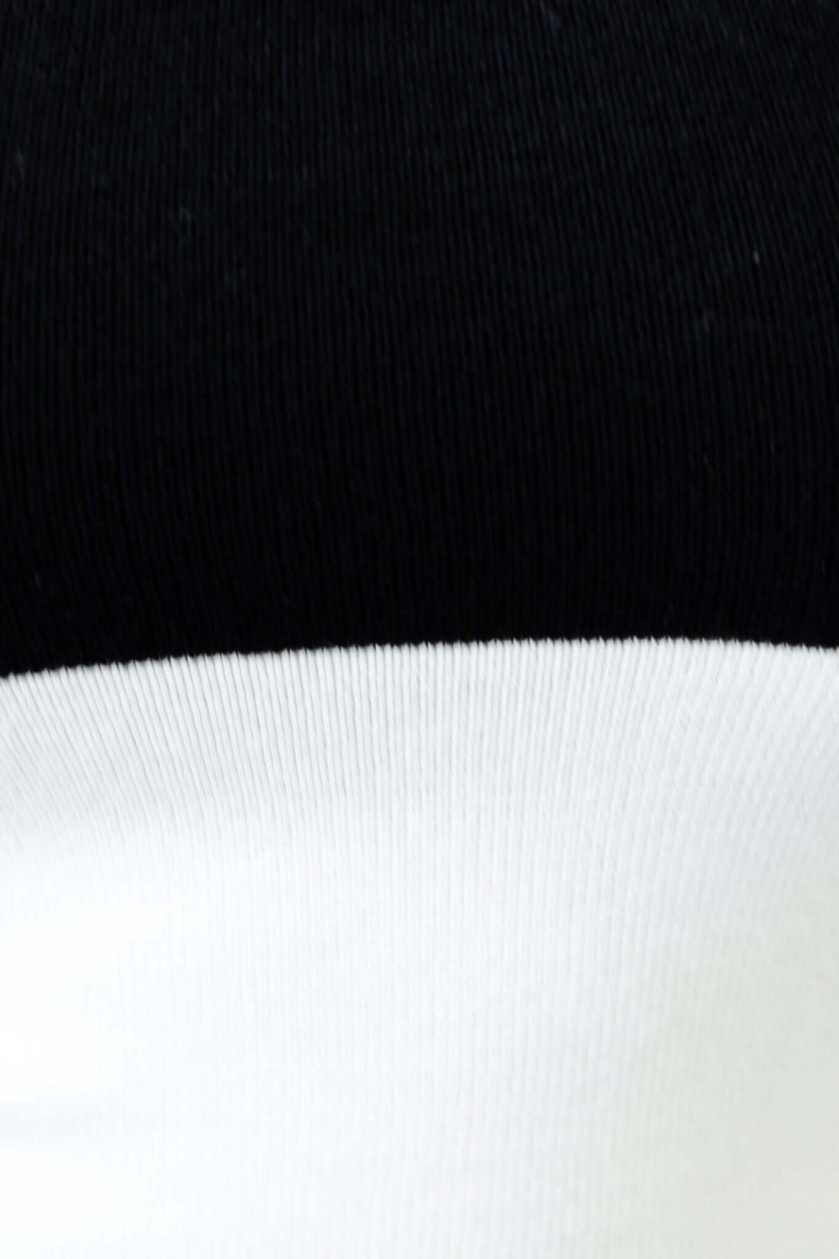 Close-up detail of the Alonza Midi Dress showcasing the black and white knit fabric texture.