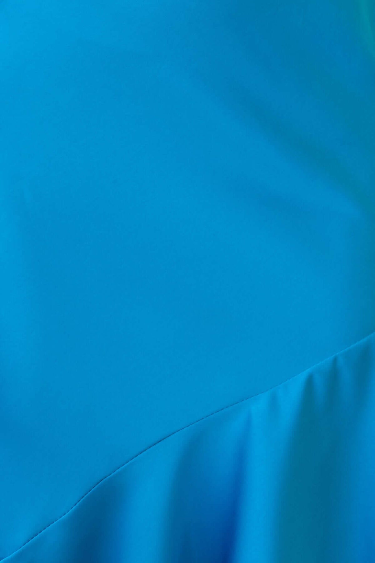 Close-up of the vibrant blue fabric of the Ramona Maxi Dress, showcasing smooth textures and elegant draping.