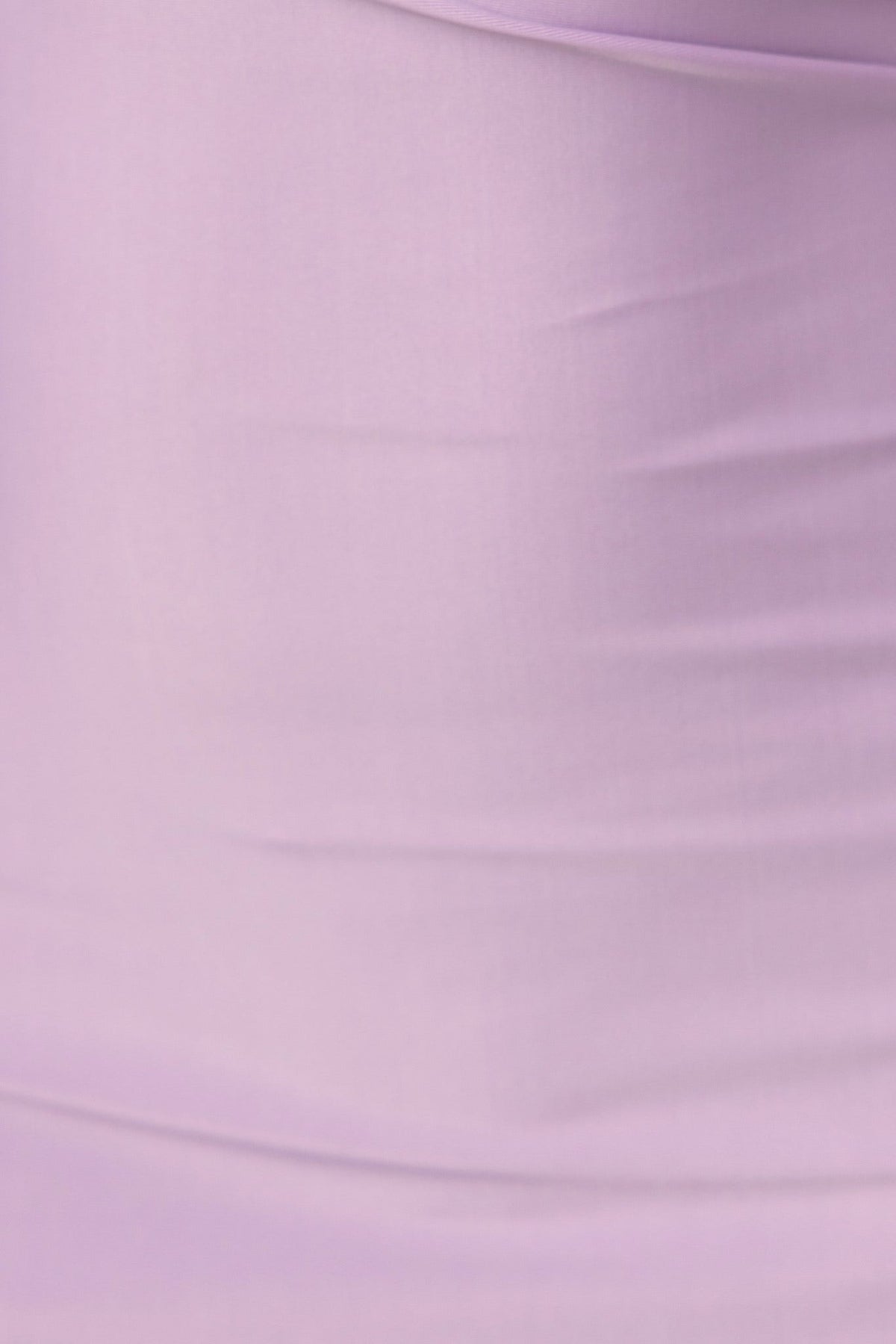 Close-up of the slinky fabric of the Carisha Dress in soft lavender color, showcasing smooth texture and stretch.