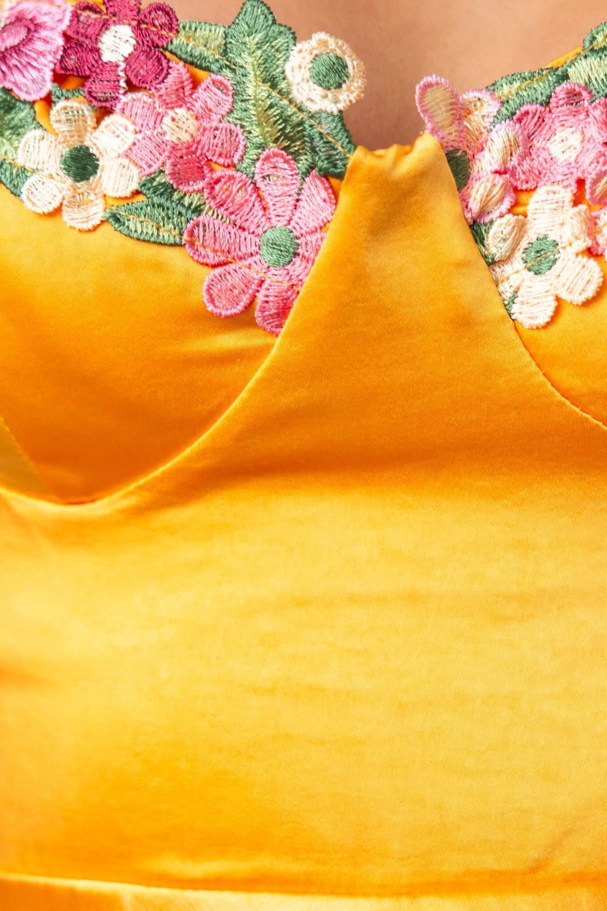 Close-up of the Angels Like You dress featuring a floral embroidered bust and satin-like fabric in vibrant yellow.