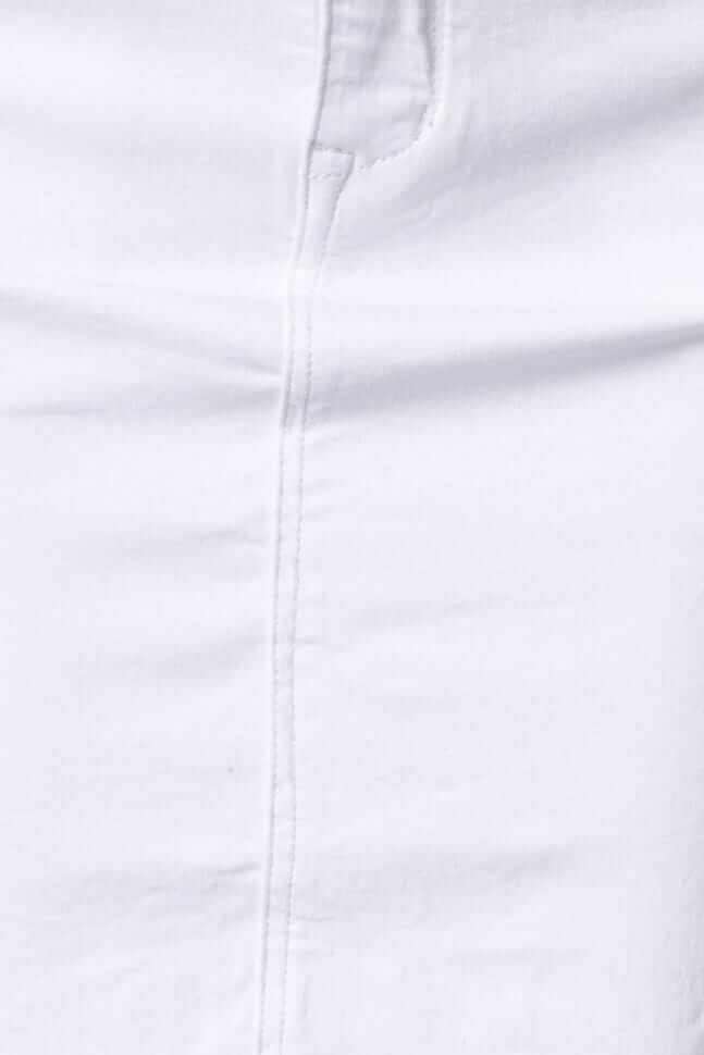 Close-up view of a white denim skirt fabric featuring a clean seam and classic design.