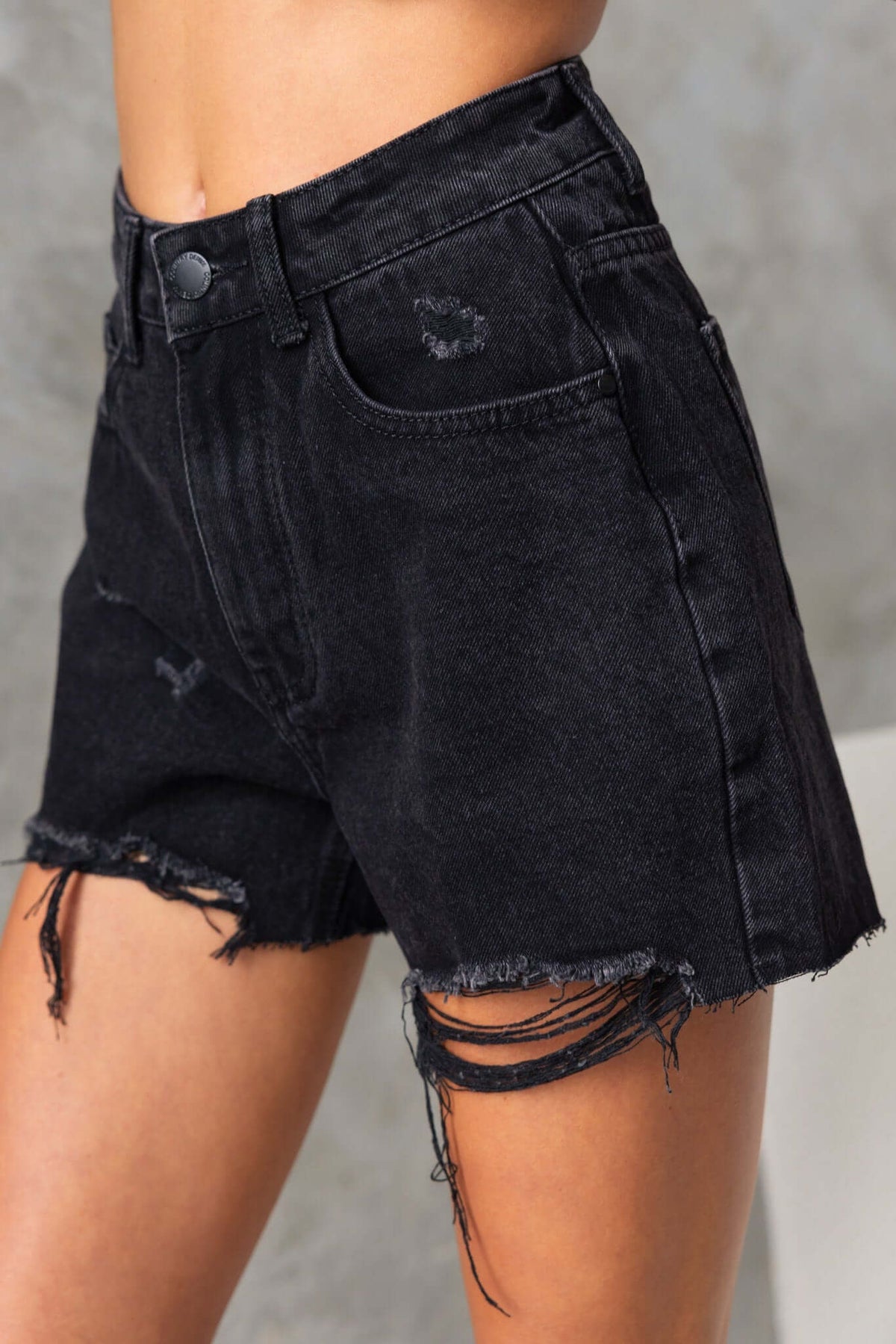 San Diego Denim Shorts in washed black with distressed rips and raw hemline, featuring front and back pockets.