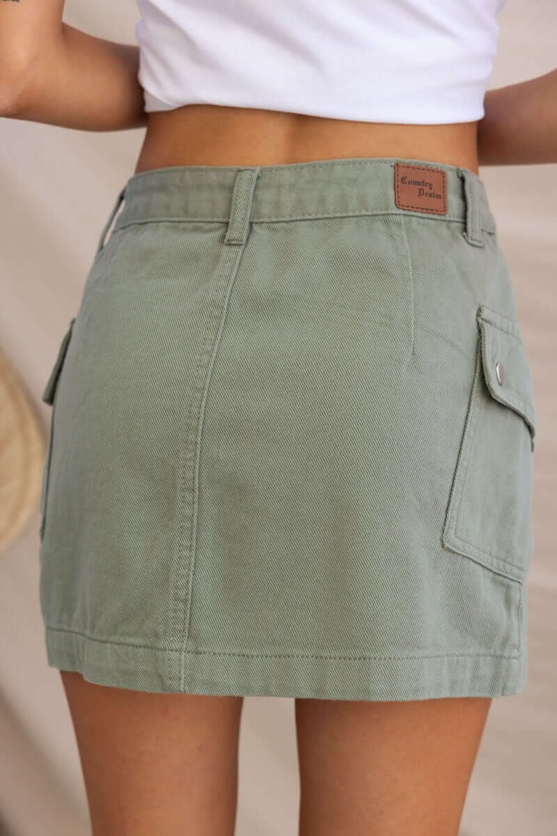 Effortless denim skirt in olive green, featuring side pockets and a standard fit, made from 100% cotton.
