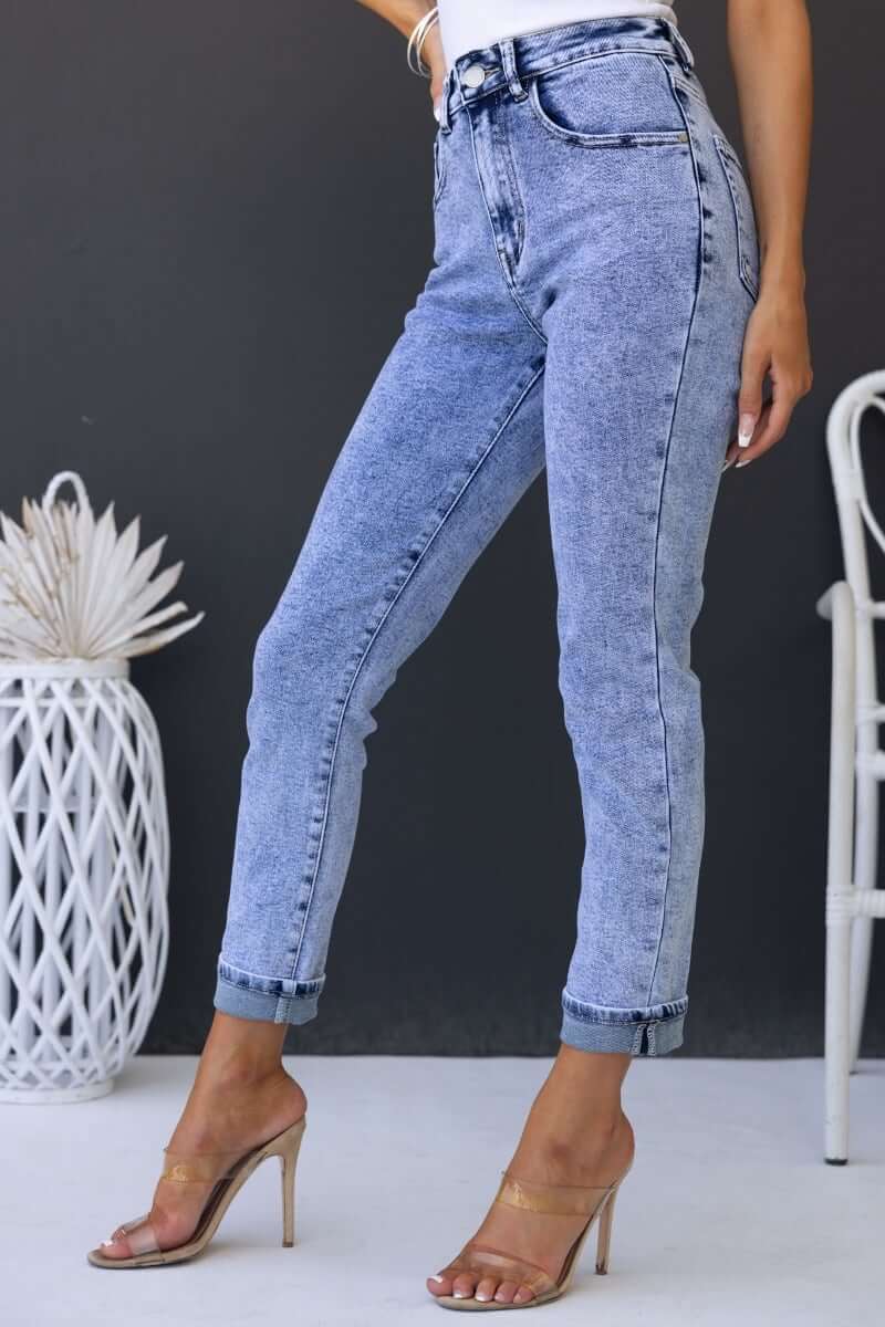 Hush Mom Jeans shown on model, featuring mid-high waist, firm stretch denim, and rolled cuffs in light wash.