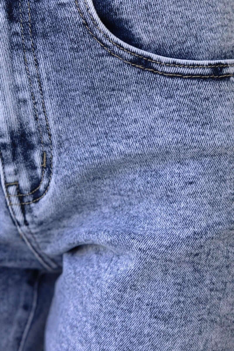 Close-up view of Hush Mom Jeans featuring a mid-high waist, front pocket, and firm stretch denim in a light wash.