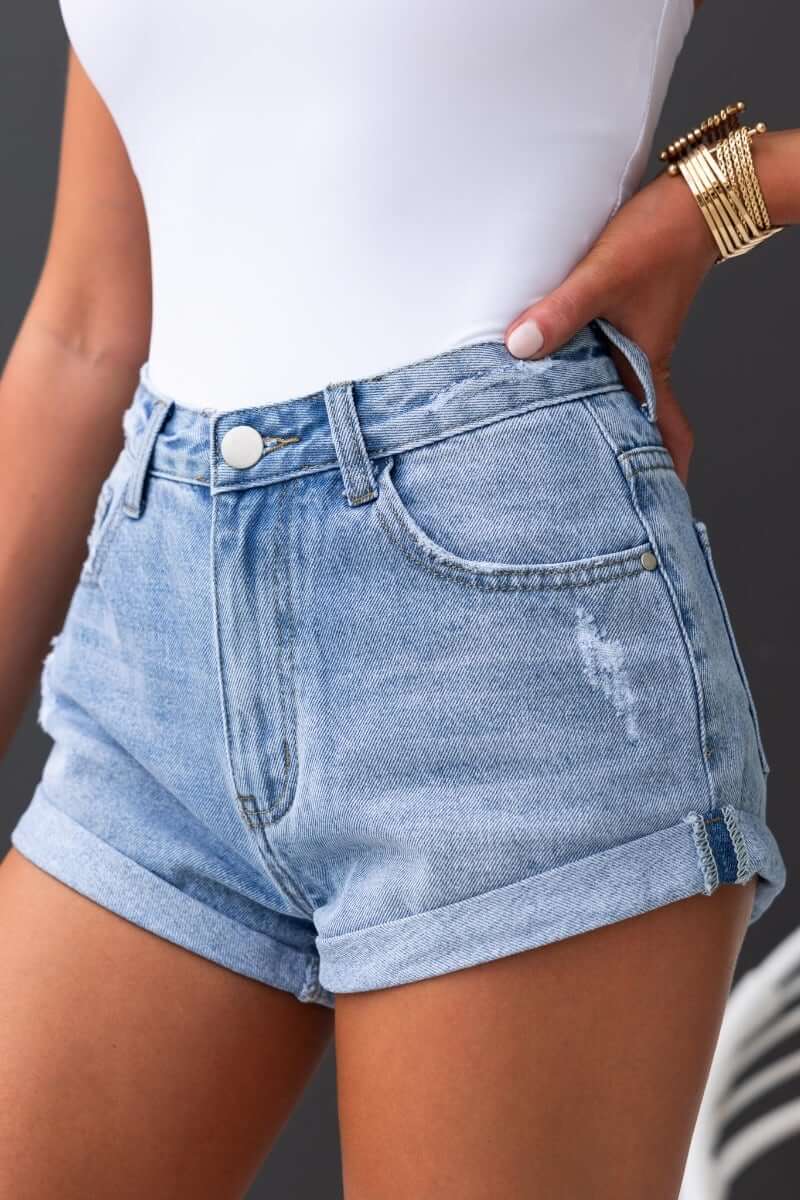 Kim Denim Shorts with mid-high waist and distressed detailing, perfect for casual summer outfits.