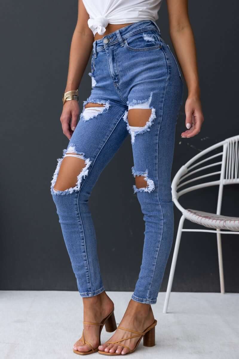 Fletcher Jeans featuring mid-high waist, distressed rips, and a skinny fit for a trendy casual look.