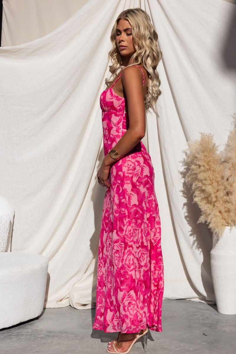 Model wearing the Freyda Maxi Dress, a pink floral multi-colour dress with adjustable straps and a gathered bust.