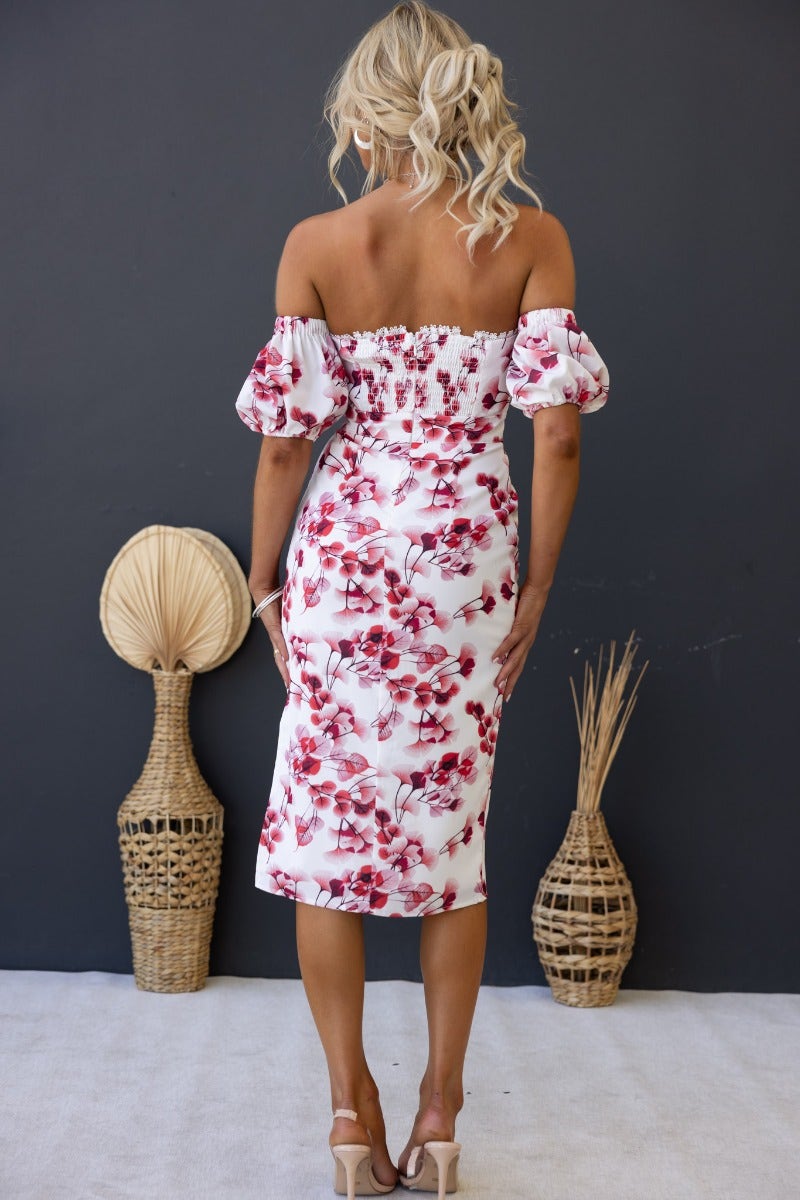 Back view of the Flourish Midi Dress featuring an off-shoulder neckline and floral print, perfect for spring events.