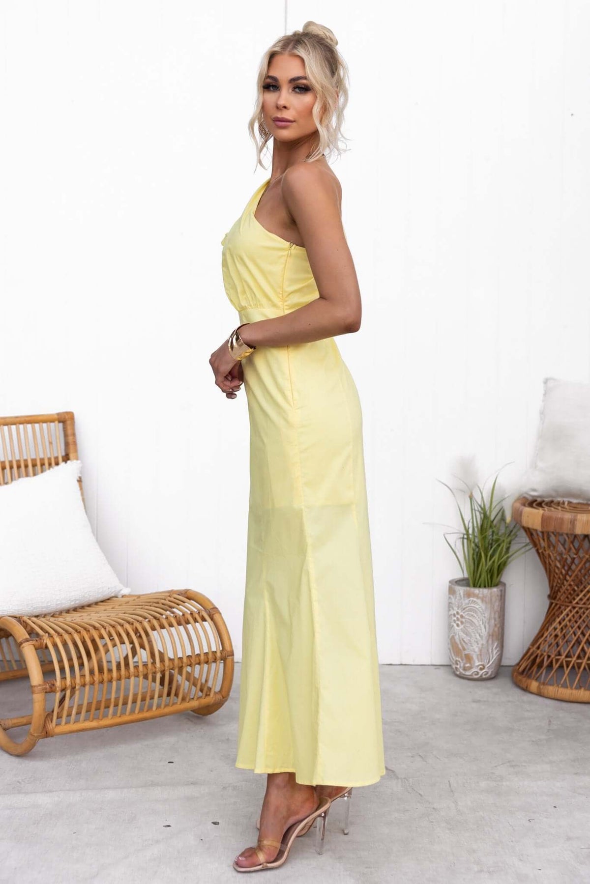 Model wearing the yellow Hopewell Maxi Dress with one-shoulder neckline, styled in a casual setting.