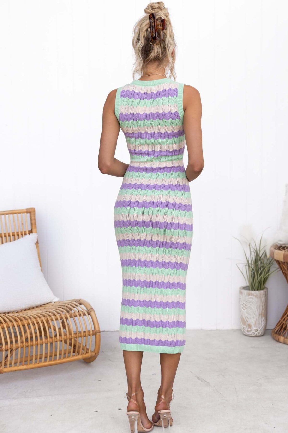 Back view of the Jax Midi Dress featuring a round neckline and colorful striped pattern in purple and green hues.