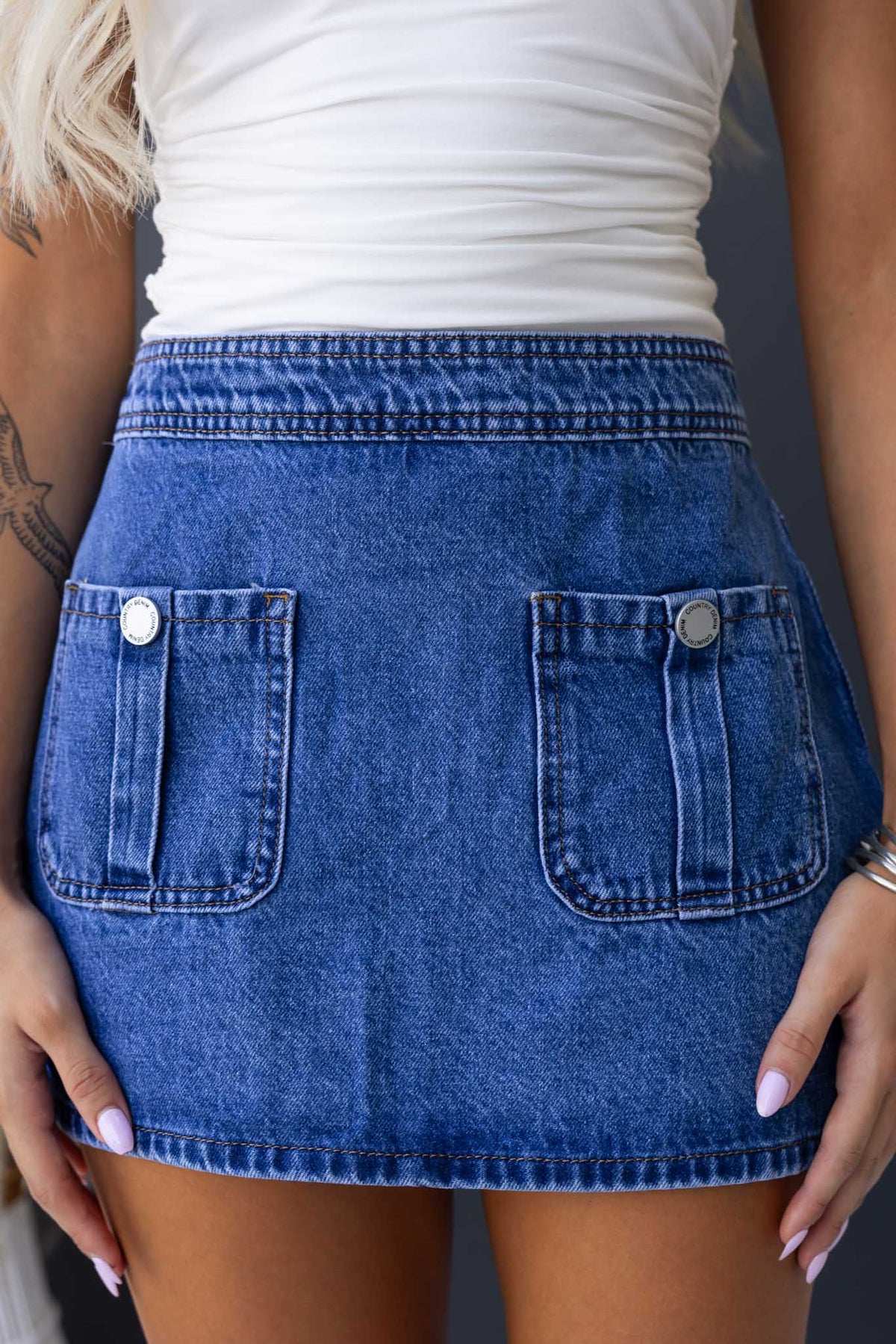 Classic Colorado denim skirt featuring front pockets and a back zip closure, ideal for casual wear.