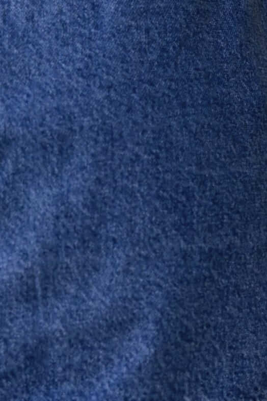 Close-up of Colorado Denim Skirt fabric showing deep blue cotton texture for stylish casual wear.
