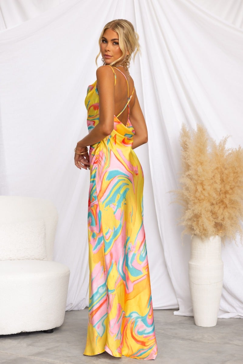 Visionary Maxi Dress featuring a colorful satin design, cowl neckline, and adjustable straps at the back.