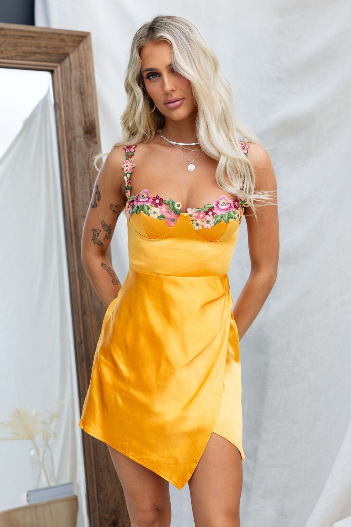 Angels Like You Dress features adjustable straps, padded bust, and floral embroidery; a stylish mini dress in vibrant yellow.