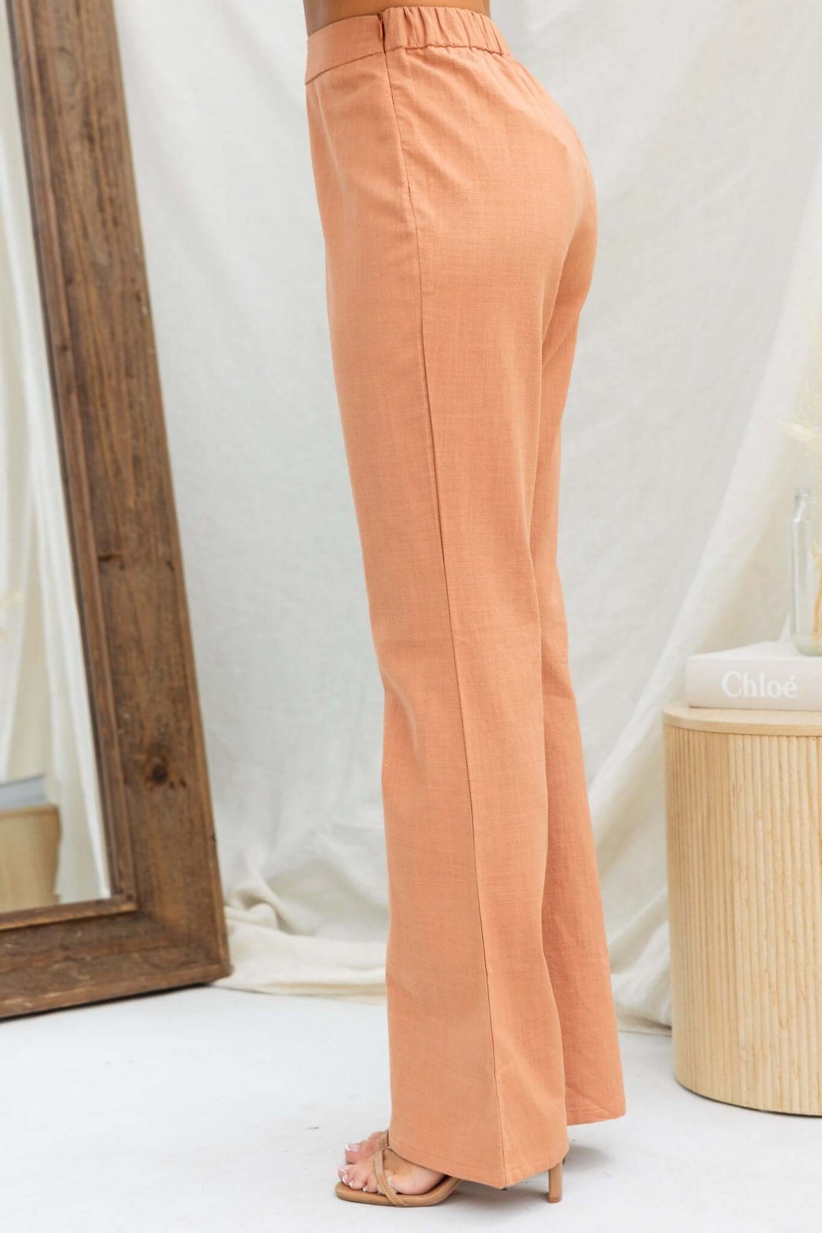 Stelline Pants in soft peach color, featuring mid-high waist fit and elastic back for comfort.