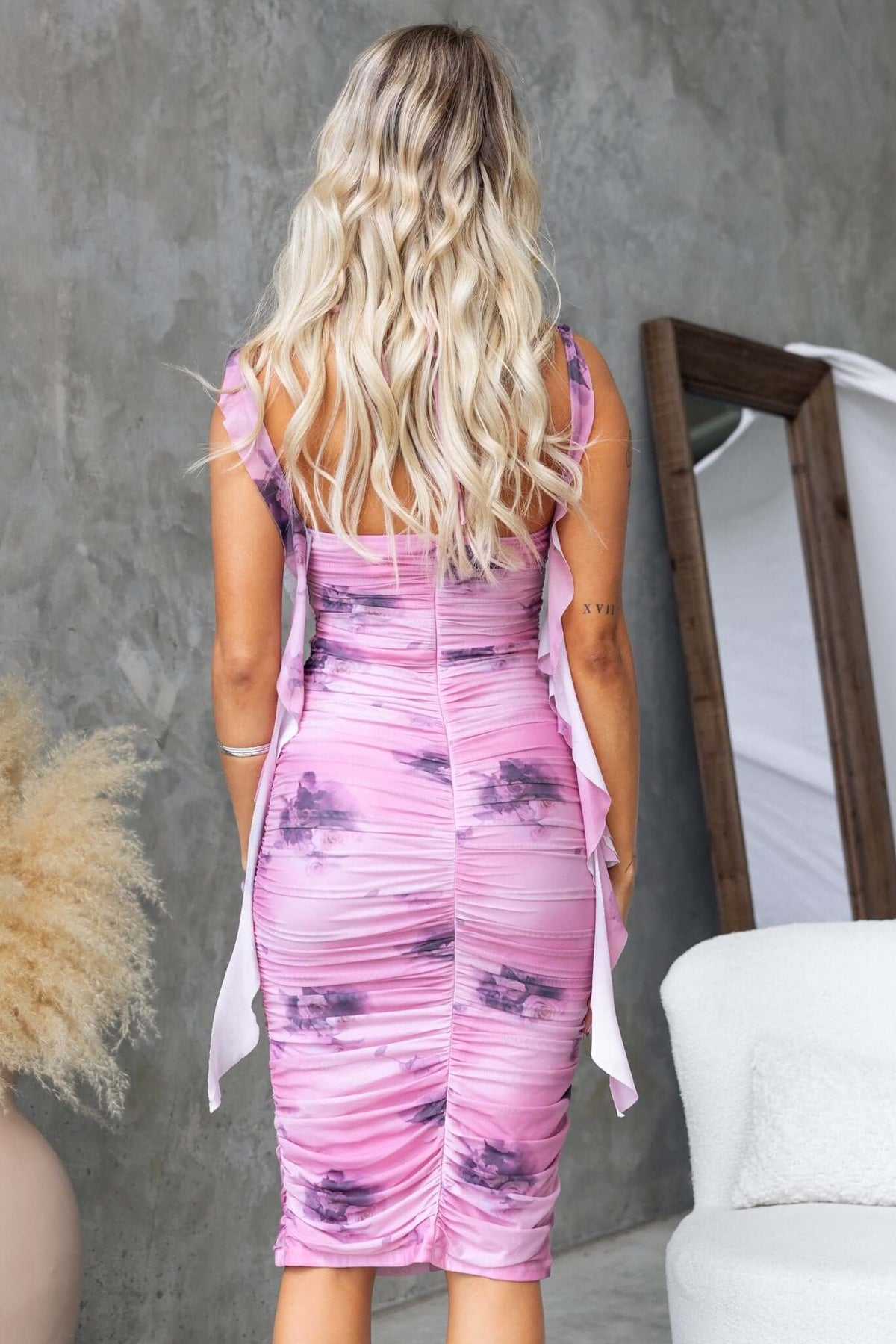 Back view of Dayania Midi Dress featuring a floral print, ruching, and adjustable tie neckline.