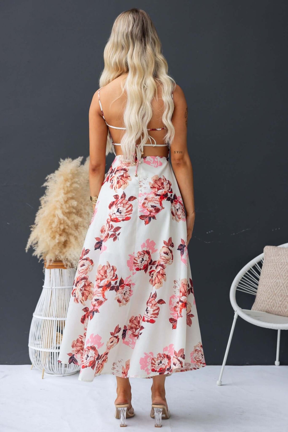 Back view of Burkes Midi Dress featuring floral design, adjustable tie straps, and a flowy silhouette.