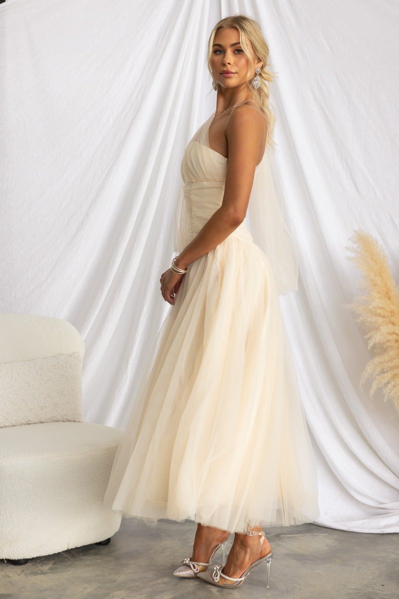 Elegant Belle maxi dress featuring tulle overlay and one-shoulder neckline, styled on a model in a light setting.